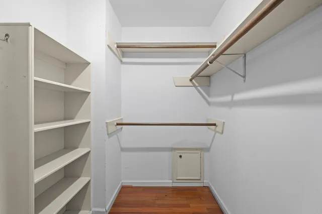 a view of walk in closet with empty racks