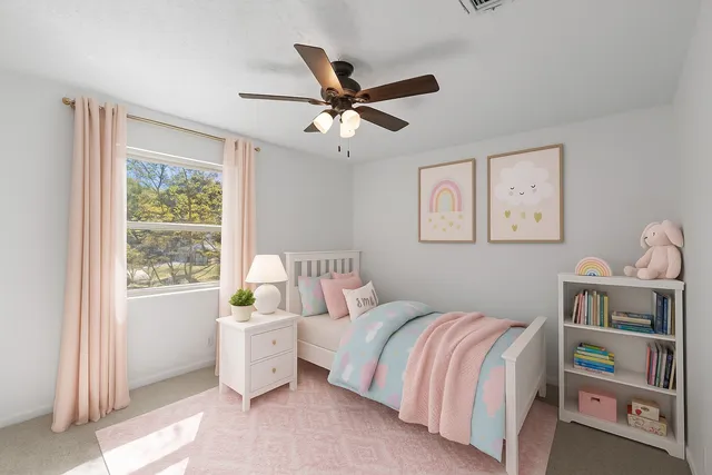 a bedroom with a bed and a window