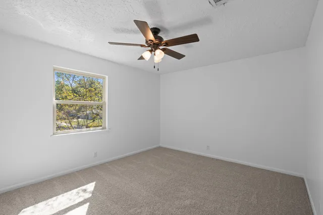 a view of room with window and ceiling fan