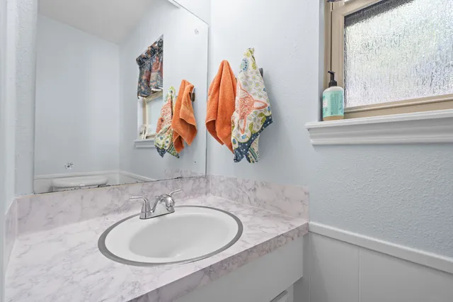 a bathroom with a sink and a mirror