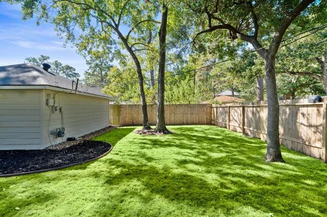 a view of a backyard with barn and a large tree