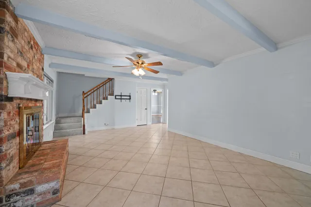 a view of a livingroom with wooden floor and a fireplace