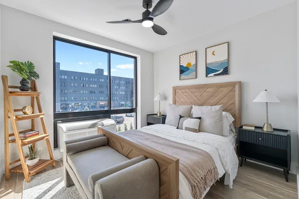 a bedroom with a large bed and a window