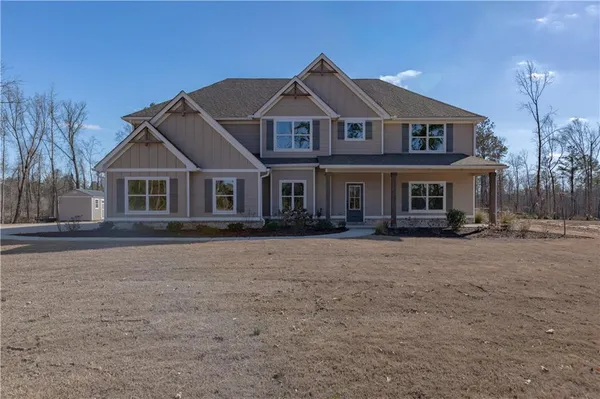 a view of a house with a yard and covered with snow