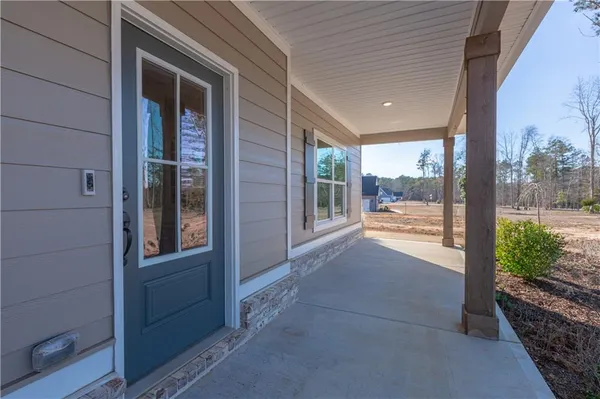 a kitchen with granite countertop white cabinets stainless steel appliances and wooden floor