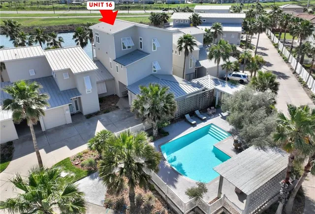 an aerial view of a house with a yard and outdoor seating