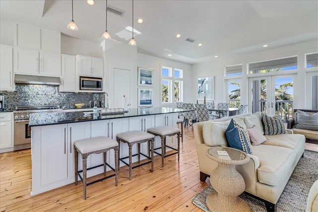 a living room with kitchen island furniture and a wooden floor