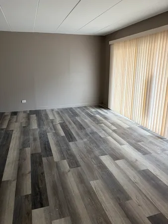 an empty room with wooden floor