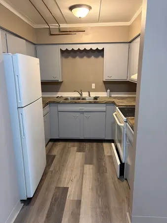 a kitchen with granite countertop a refrigerator and a stove