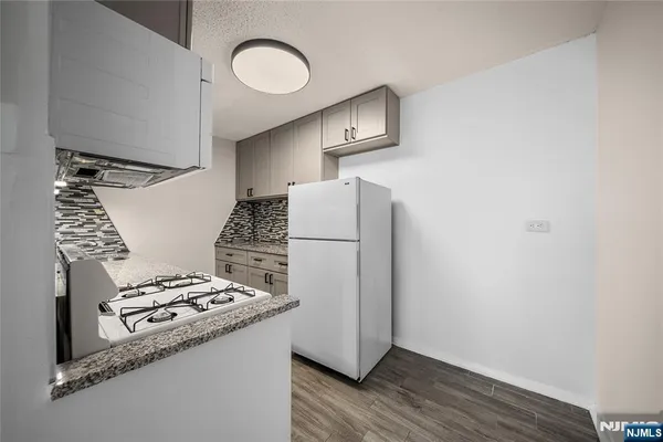 a view of a room with a kitchen