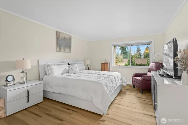 a bedroom with a bed and a flat screen tv