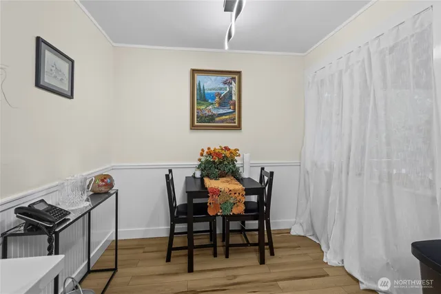 a view of a dining room with furniture and wooden floor