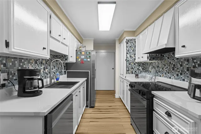 a kitchen with a sink stove and cabinets