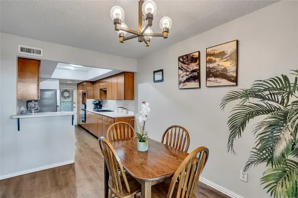 a view of a dining room with furniture and a chandelier