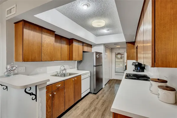 a kitchen with a sink appliances and cabinets