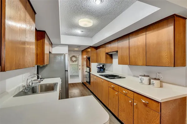 a kitchen with stainless steel appliances a sink stove and cabinets