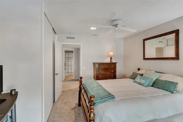 a bedroom with a bed and a lamp
