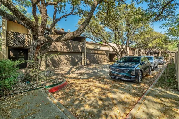 a view of a backyard with large trees