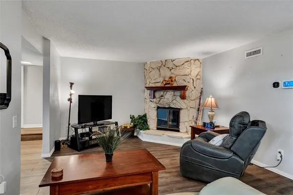 a living room with furniture a fireplace and a flat screen tv