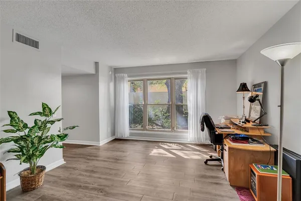 a workspace with furniture and a potted plant