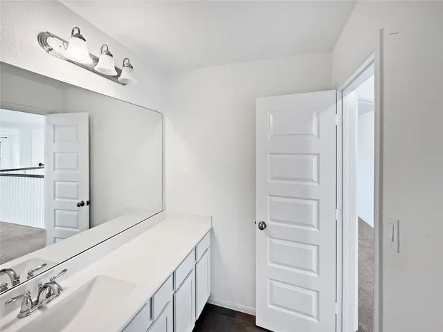 a bathroom with a sink and mirror