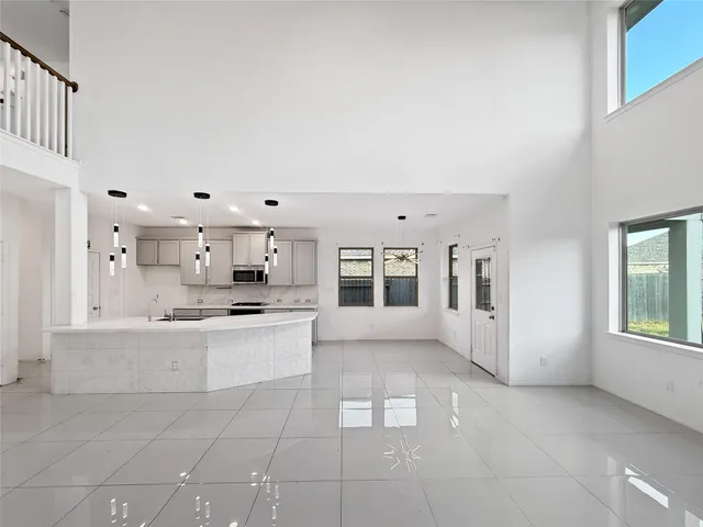 a large white kitchen with cabinets and stainless steel appliances