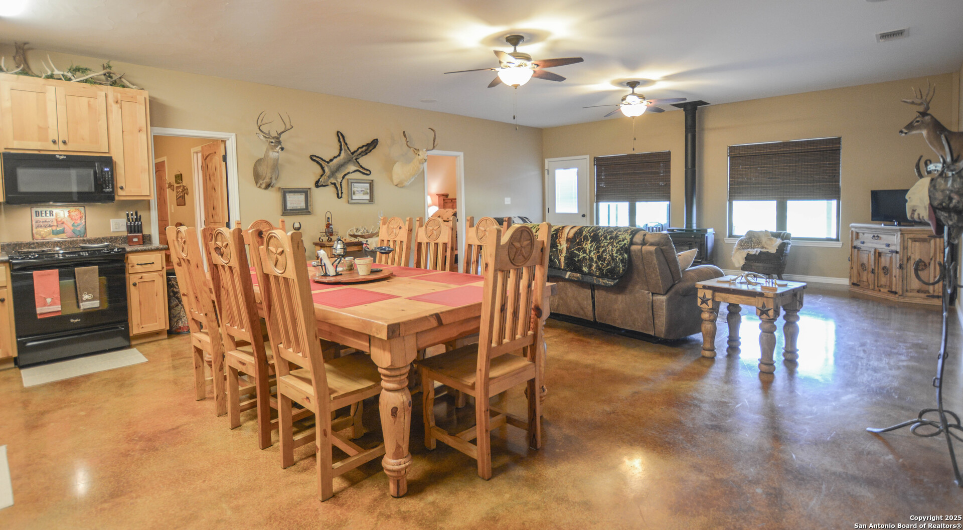 13105 Interstate 10 Service Road Junction, TX 76849 - Photo 30 of 82 a dining room with furniture a chandelier and wooden floor