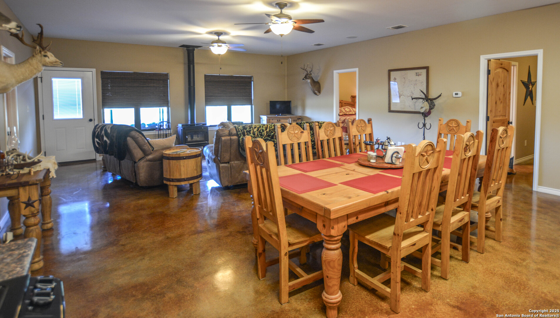13105 Interstate 10 Service Road Junction, TX 76849 - Photo 31 of 82 a living room with furniture a chandelier and a dining table