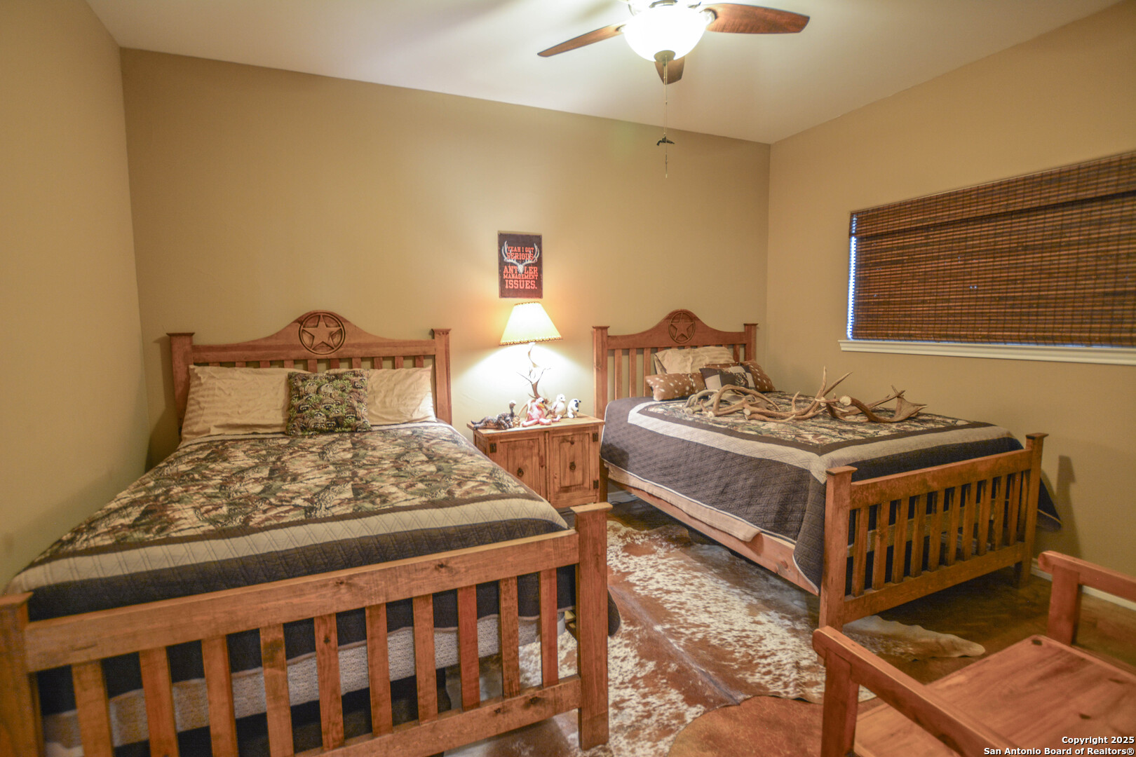 13105 Interstate 10 Service Road Junction, TX 76849 - Photo 38 of 82 a bedroom with a bed and a chandelier