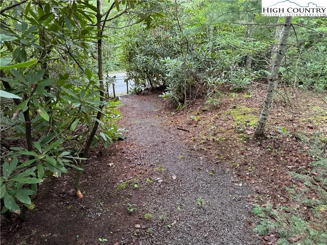 a front view of a house with a garden and parking space