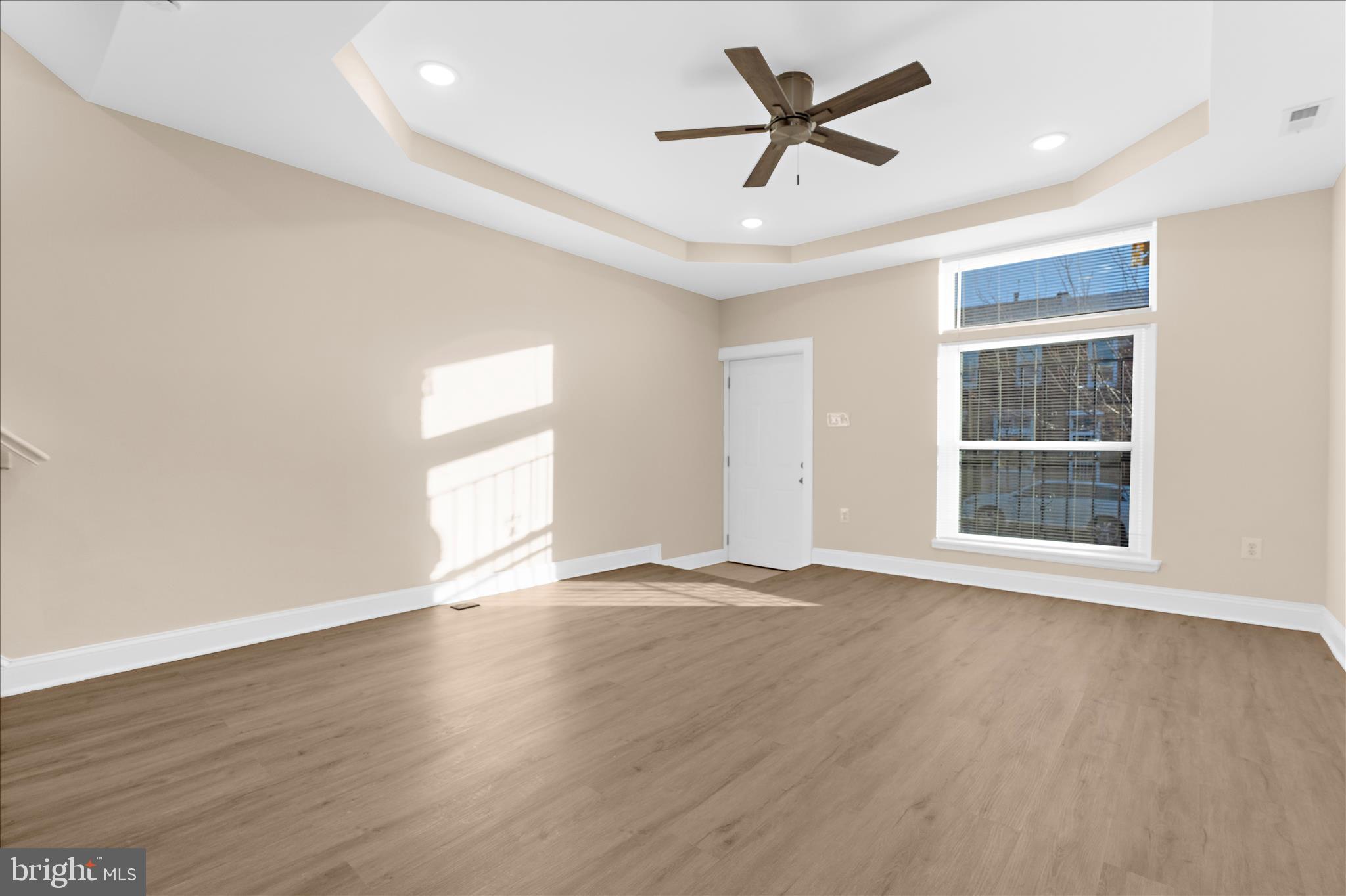1402 North Montford Avenue Baltimore, MD 21213 - Photo 11 of 40 an empty room with wooden floor and windows