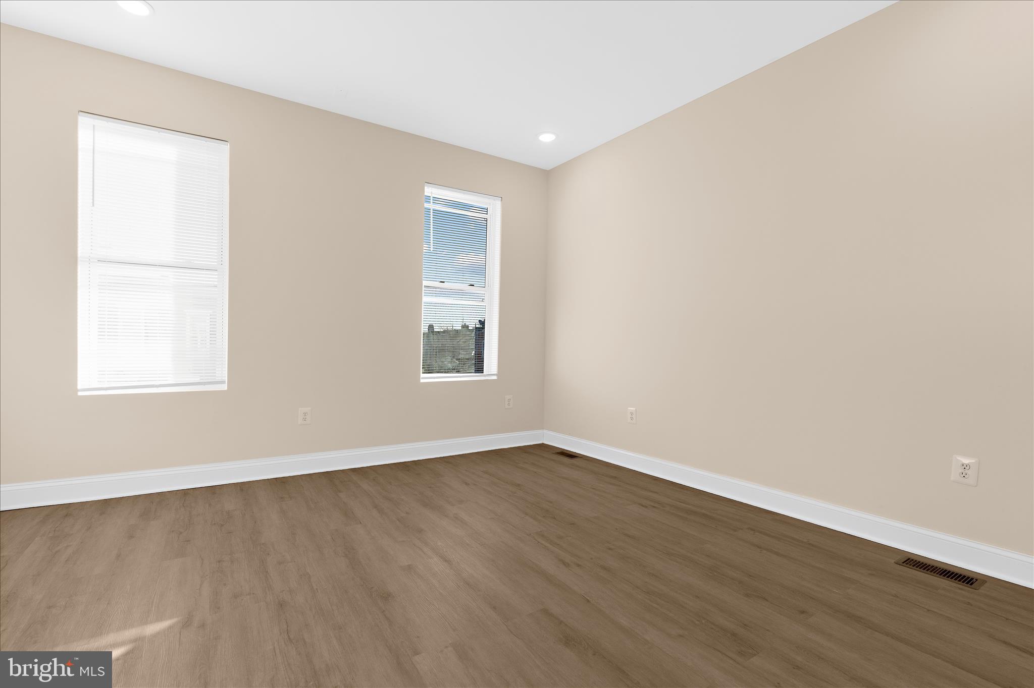 1402 North Montford Avenue Baltimore, MD 21213 - Photo 16 of 40 an empty room with wooden floor and windows
