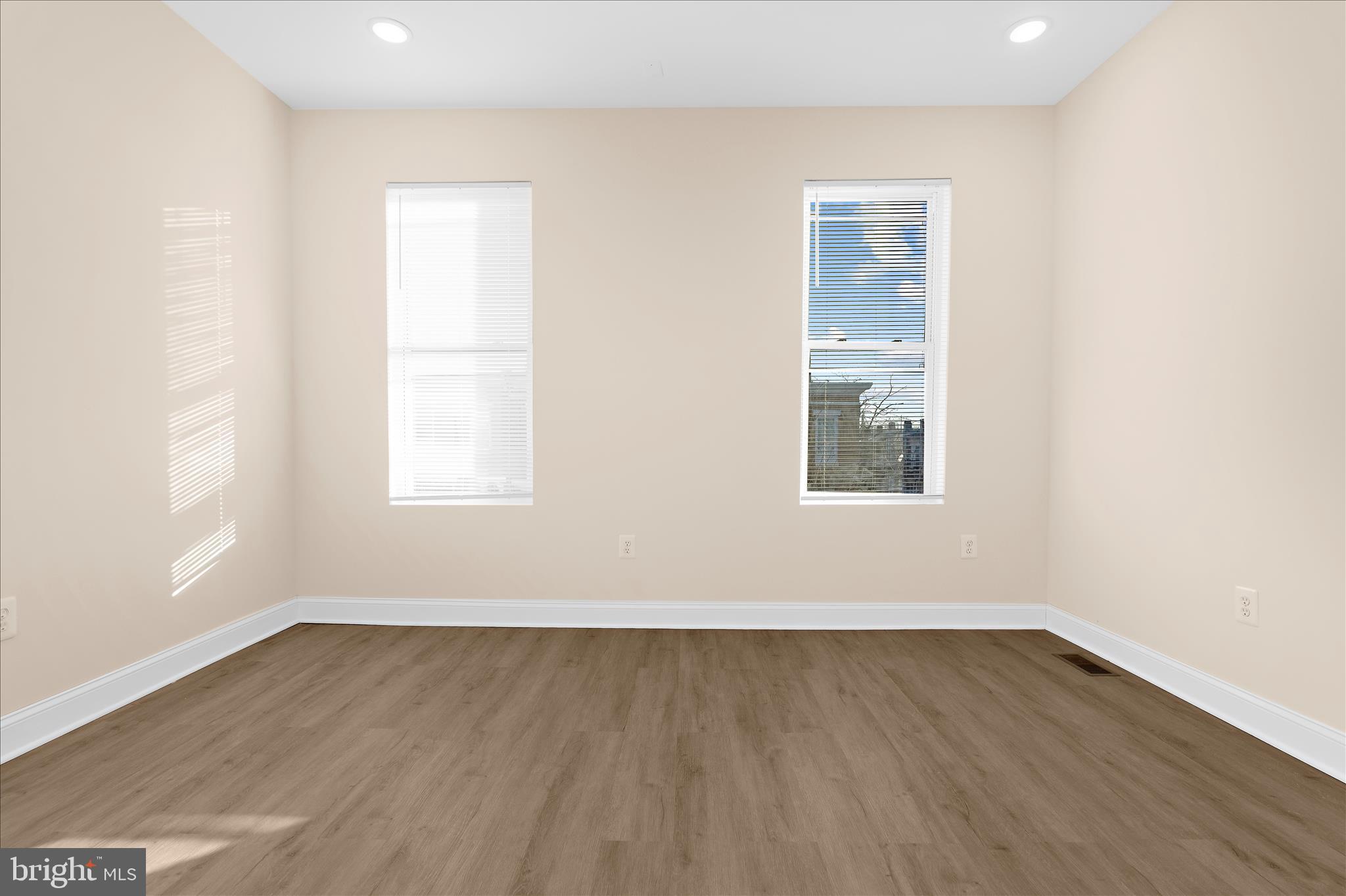1402 North Montford Avenue Baltimore, MD 21213 - Photo 18 of 40 an empty room with wooden floor and windows