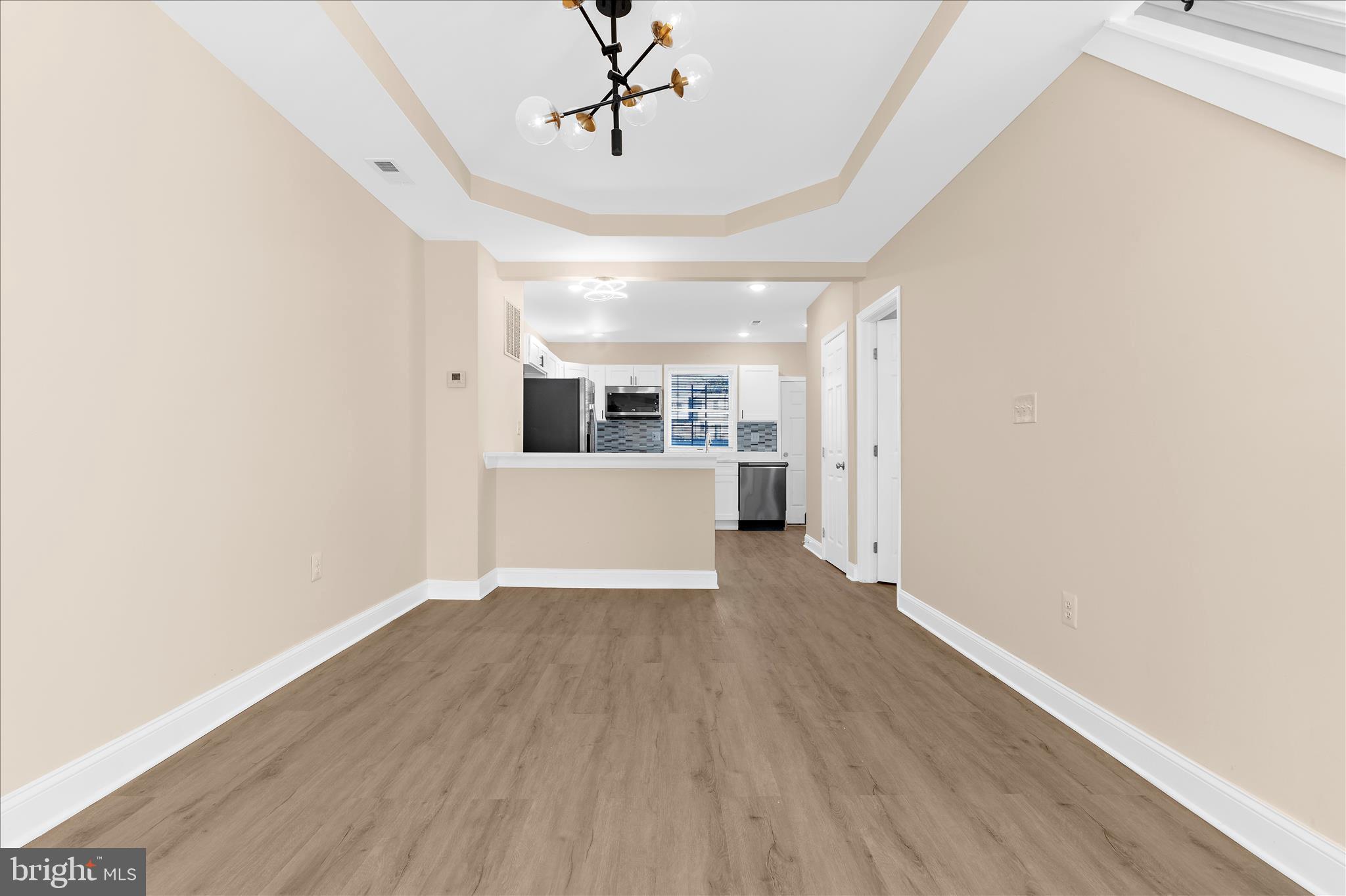 1402 North Montford Avenue Baltimore, MD 21213 - Photo 3 of 40 a view of a kitchen with wooden floor and windows