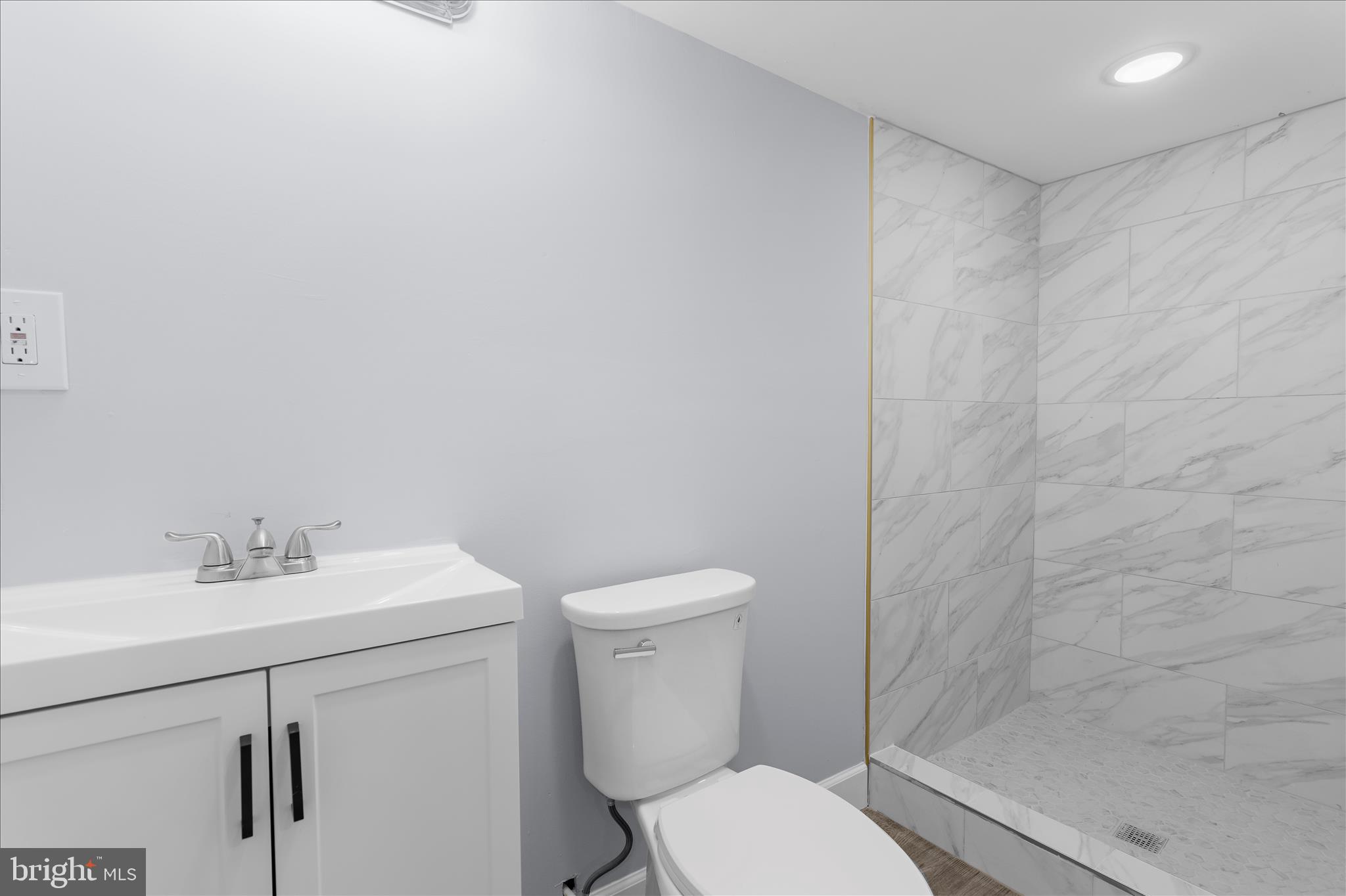 1402 North Montford Avenue Baltimore, MD 21213 - Photo 32 of 40 a bathroom with a toilet sink vanity and mirror