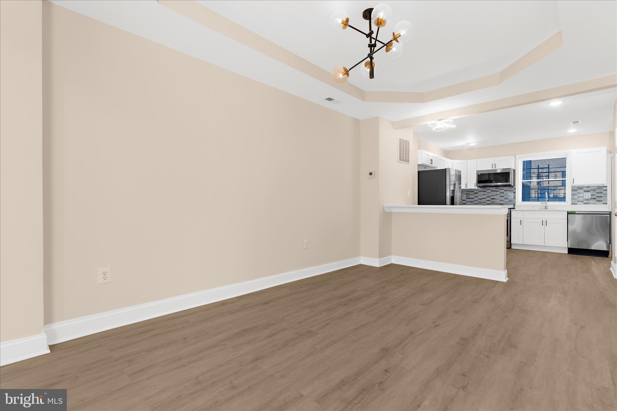 1402 North Montford Avenue Baltimore, MD 21213 - Photo 4 of 40 a view of a room with wooden floor and white walls