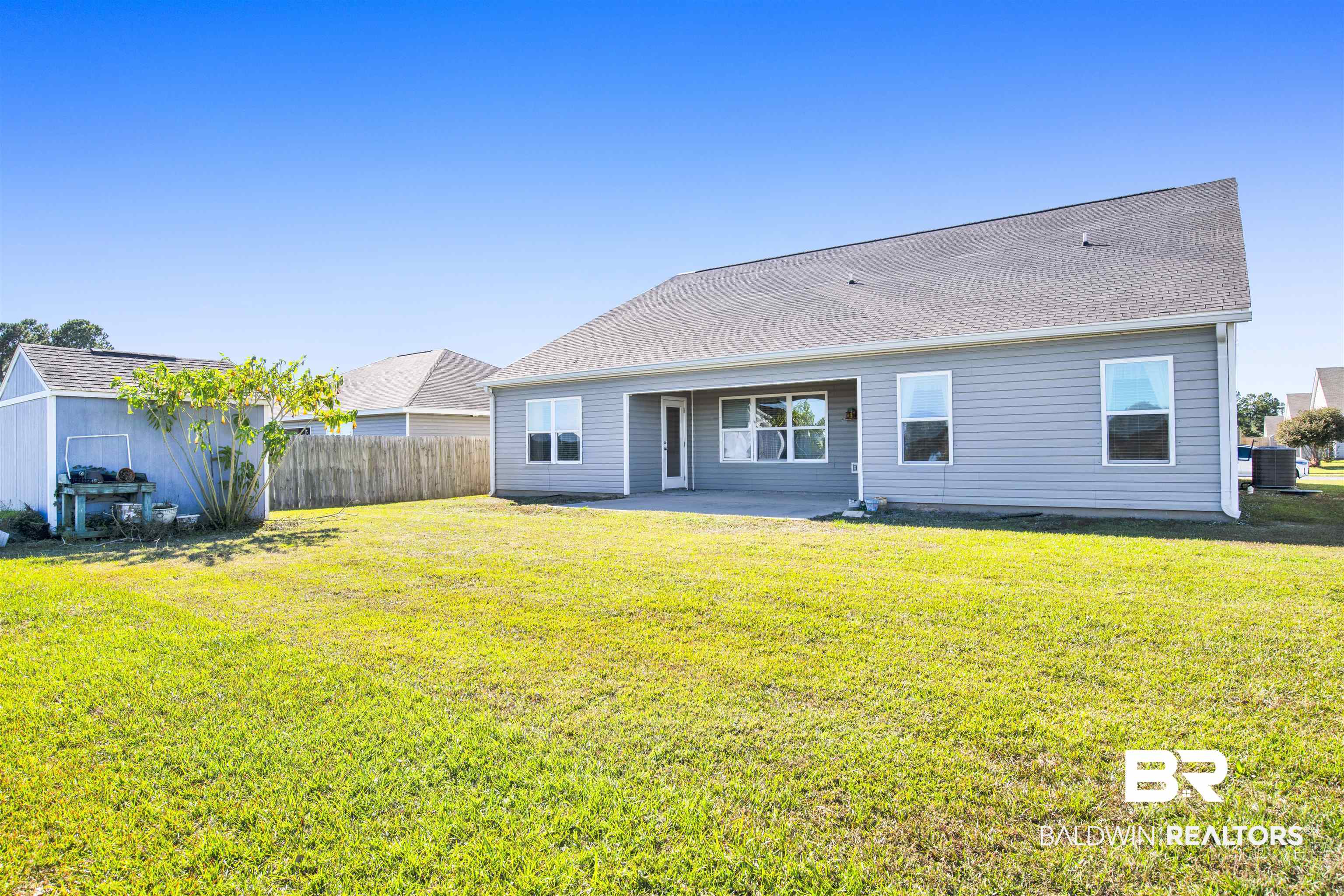 6926 Crimson Ridge Street Gulf Shores, AL 36542 - Photo 17 of 18 Rear view of property with a patio area and roof with shingles