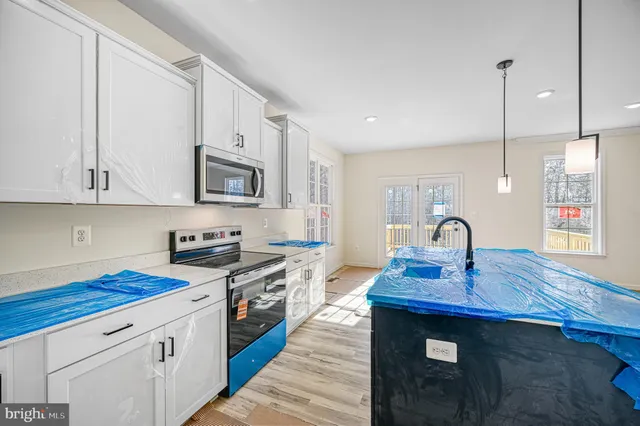 a view of a kitchen with a sink cabinets and a window