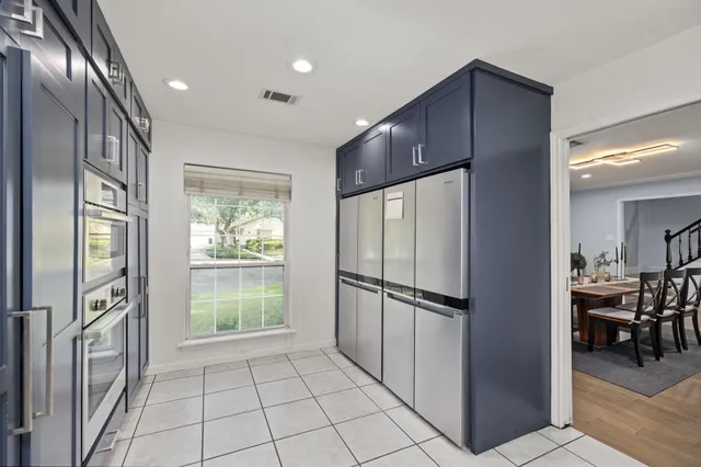a kitchen with stainless steel appliances granite countertop a refrigerator and a sink