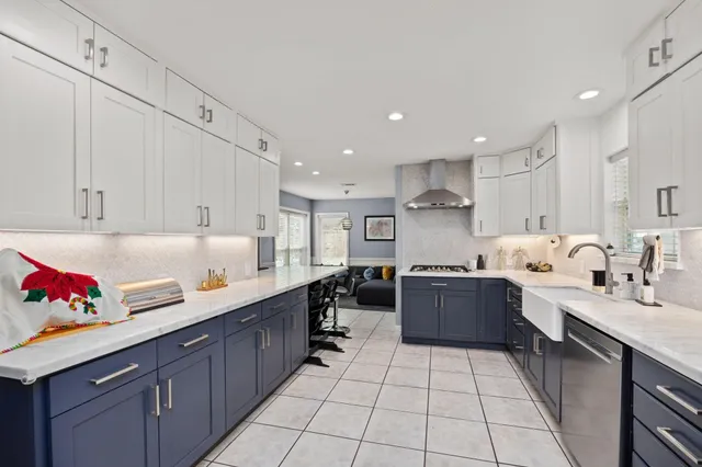 a large kitchen with stainless steel appliances lots of counter top space