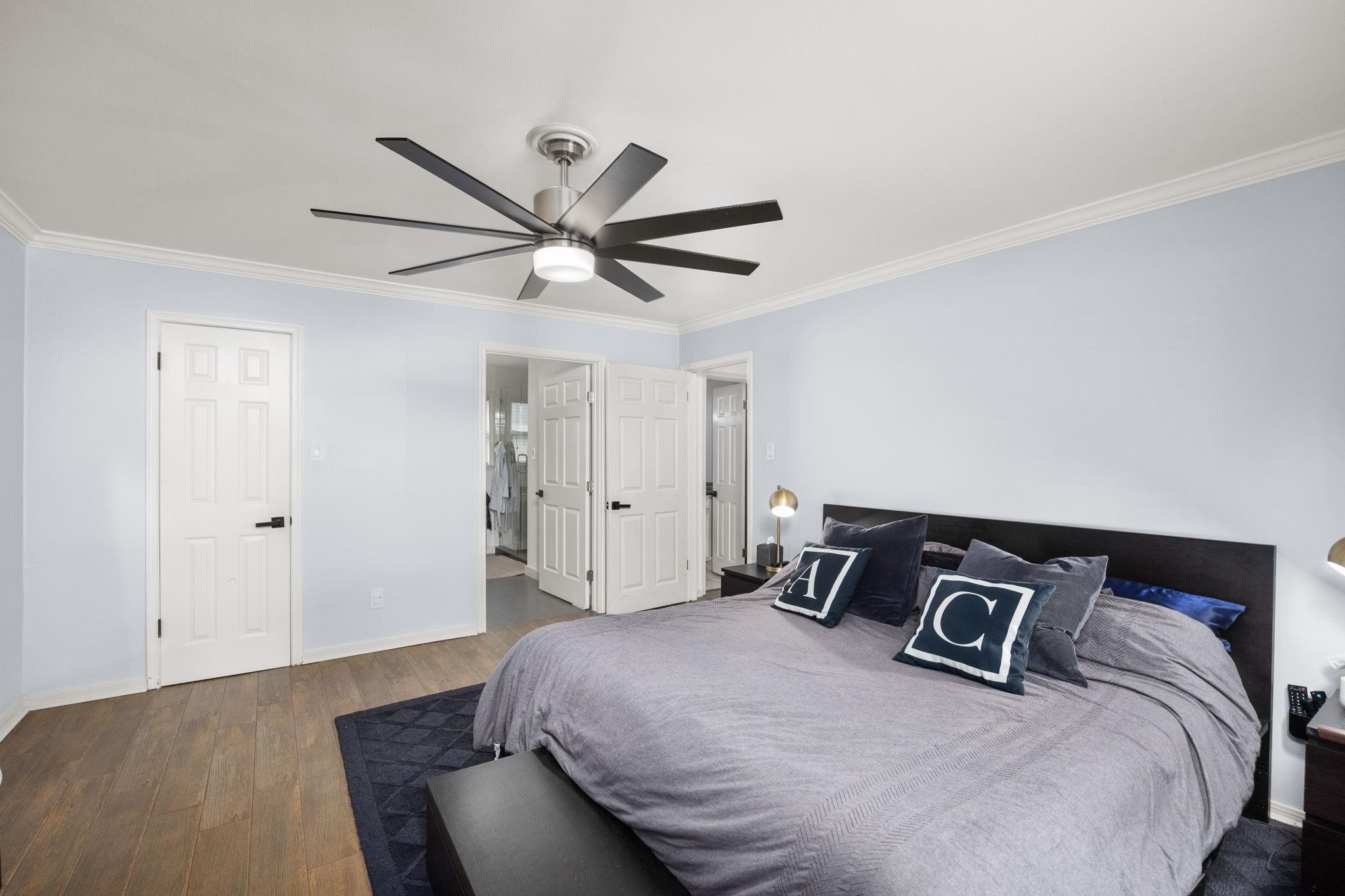 827 Thicket Lane Houston, TX 77079 - Photo 18 of 31 a bedroom with a bed and a ceiling fan