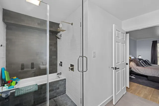 a bathroom with a tub shower sink and vanity