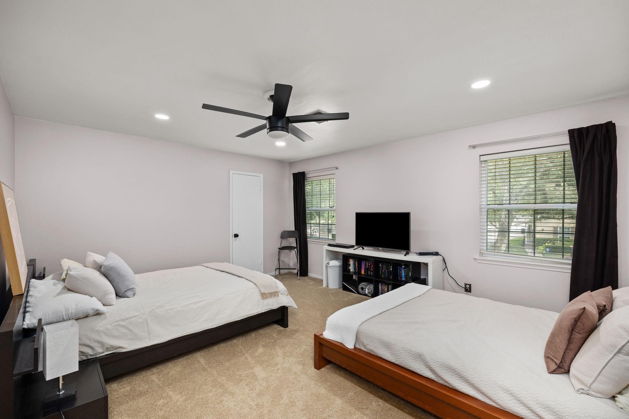 827 Thicket Lane Houston, TX 77079 - Photo 24 of 31 a bedroom with a bed and tv