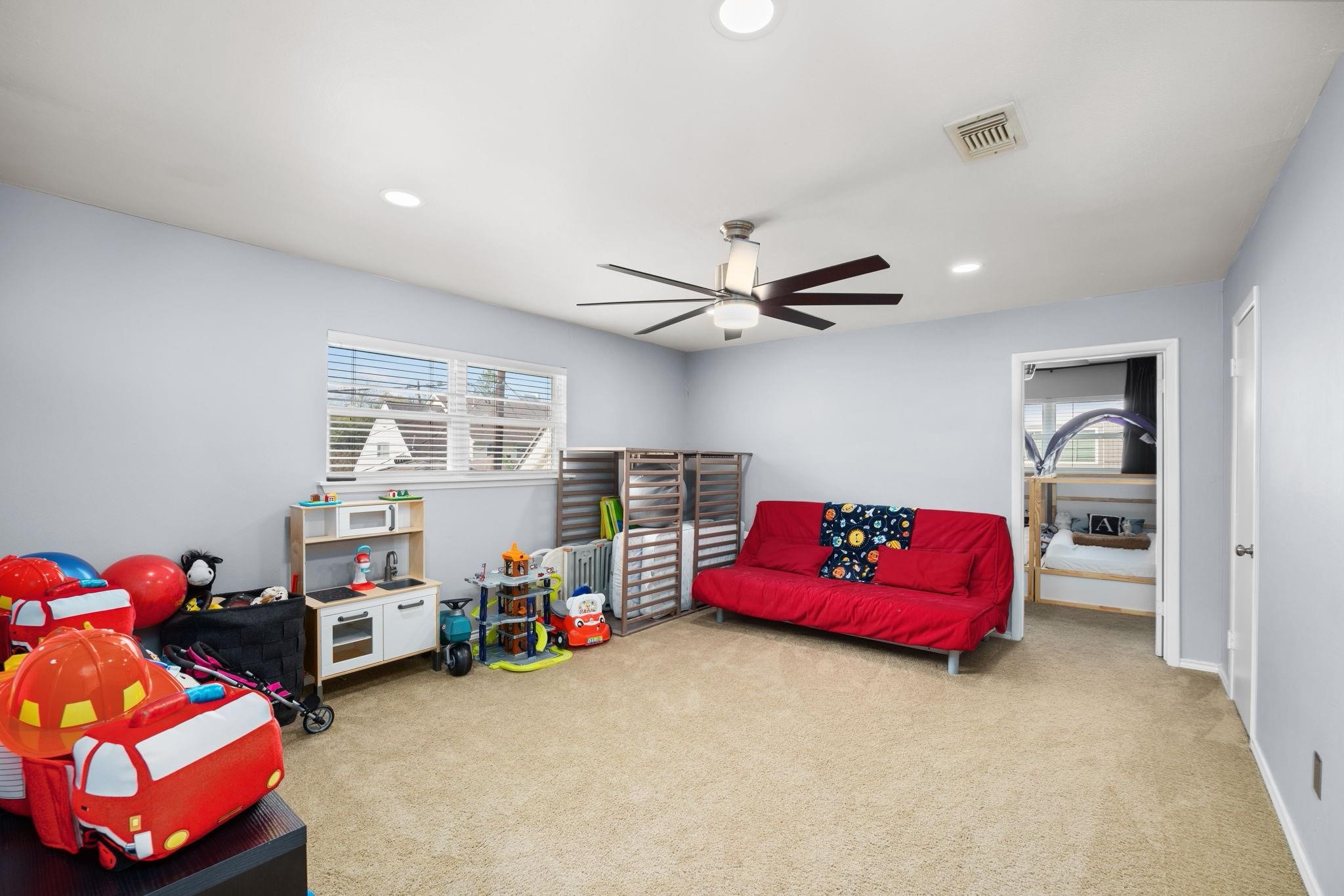 827 Thicket Lane Houston, TX 77079 - Photo 25 of 31 a living room with furniture and a window