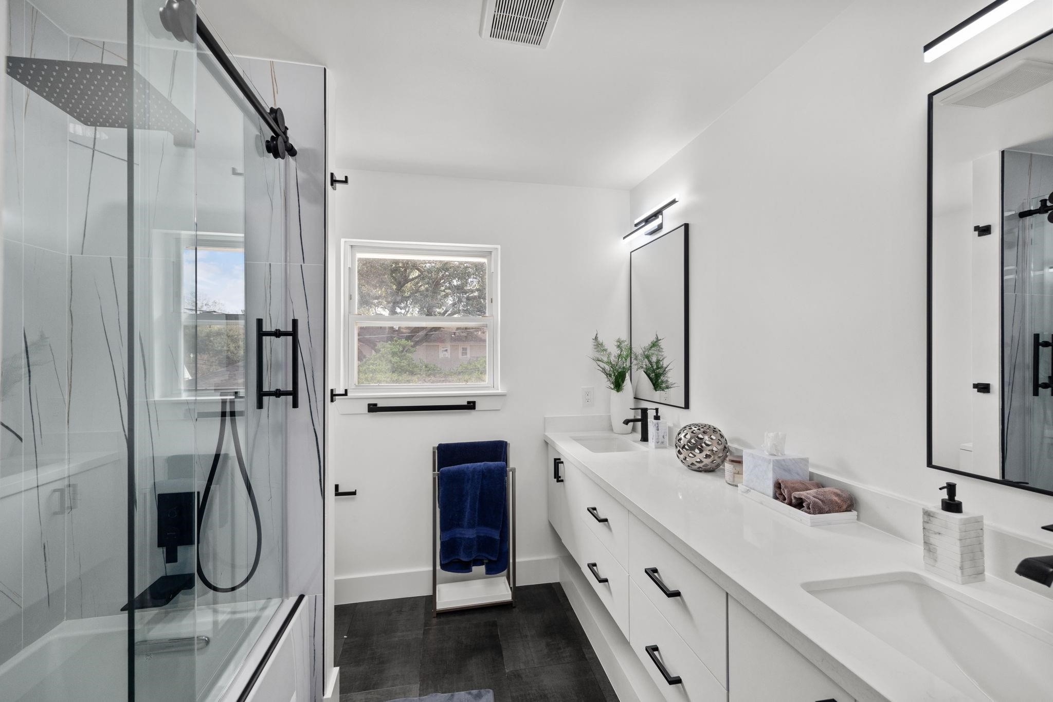 827 Thicket Lane Houston, TX 77079 - Photo 27 of 31 a bathroom with a double vanity sink a mirror a window and a shower