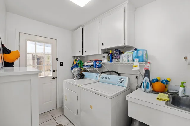a utility room with sink dryer and washer