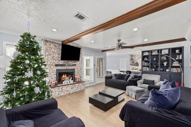 a living room with furniture a bookshelf and a fireplace