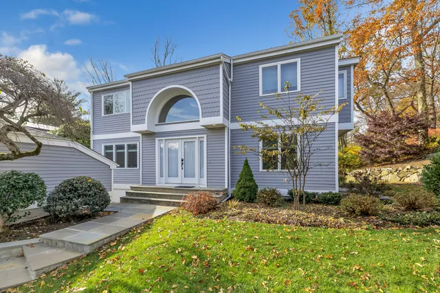 a front view of a house with garden