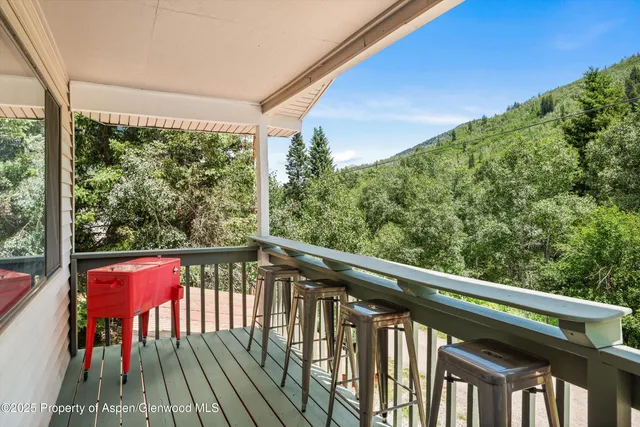 a view of balcony with wooden floor and outdoor seating
