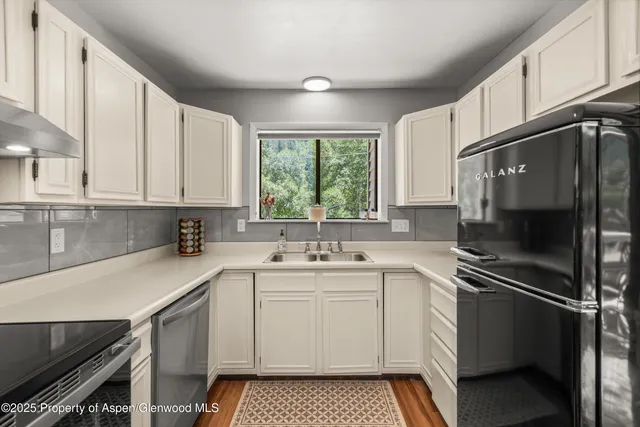 a kitchen with a sink stove and microwave